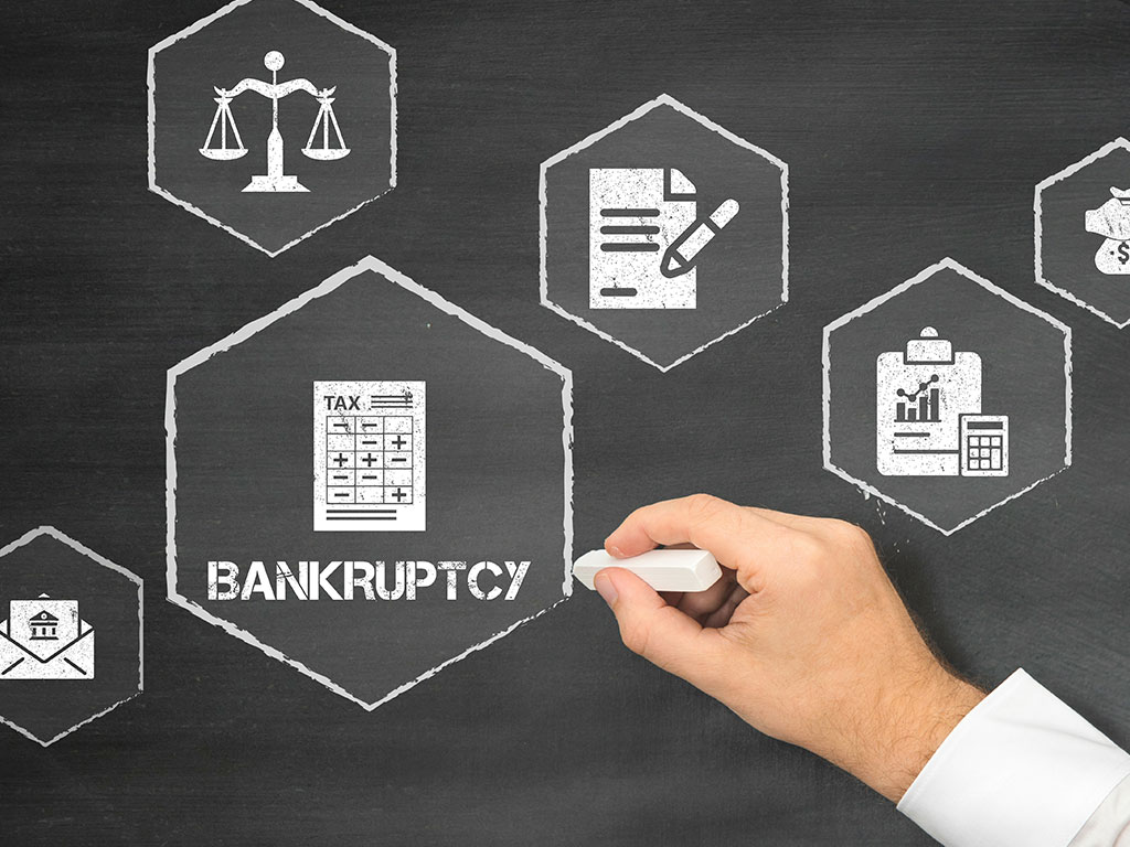 Chalk board with bankruptcy and icons on it